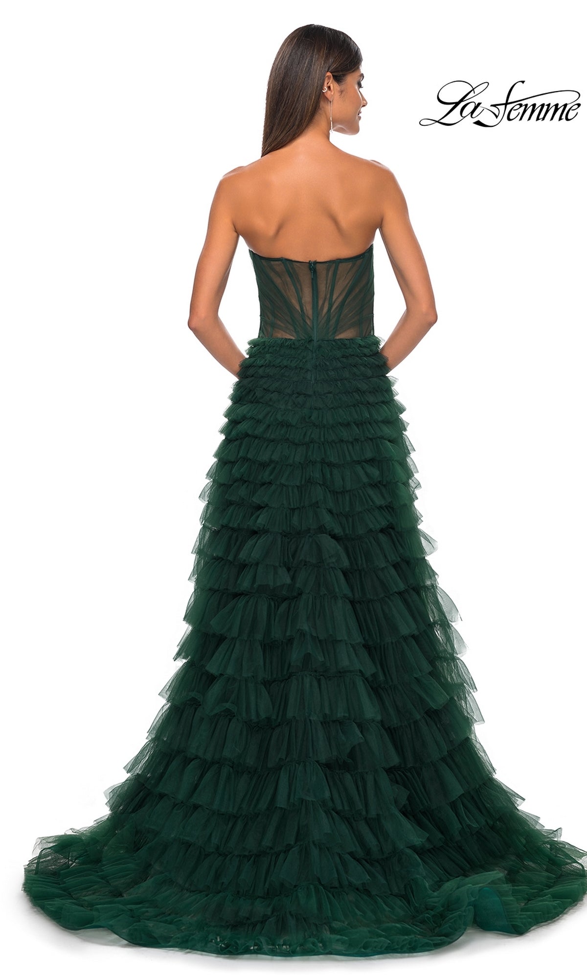 A woman models the La Femme Strapless Long Ruffled Prom Dress 32283 in dark green, featuring a fitted bodice and layered tulle A-line skirt, shown from the back with the La Femme logo in the top right corner.